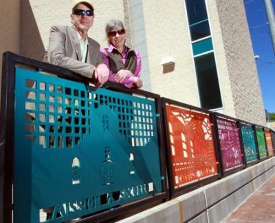 Bill and Mary Bucan of Sonarc posing with decorative fencing panels